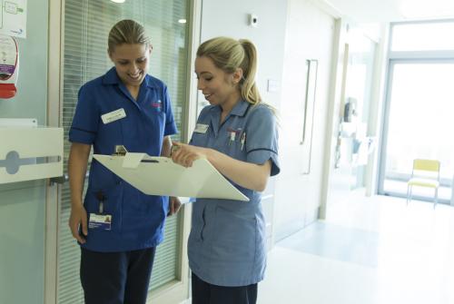 Nurses Danielle and Hannah discussing patient care on Bumblebee Ward